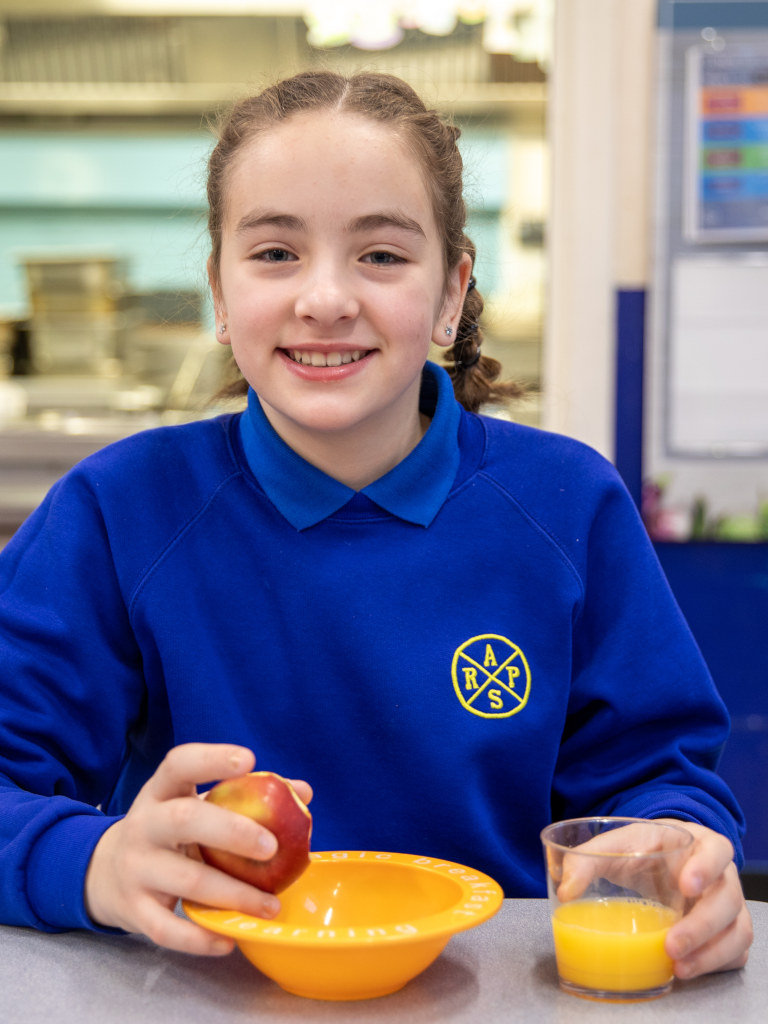 smiling girl with apple and orange juice